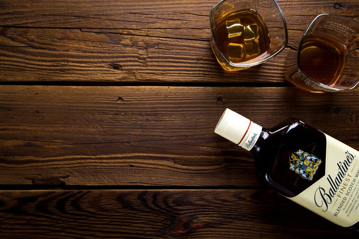 Top View of Whisky Bottle on a Wooden Background